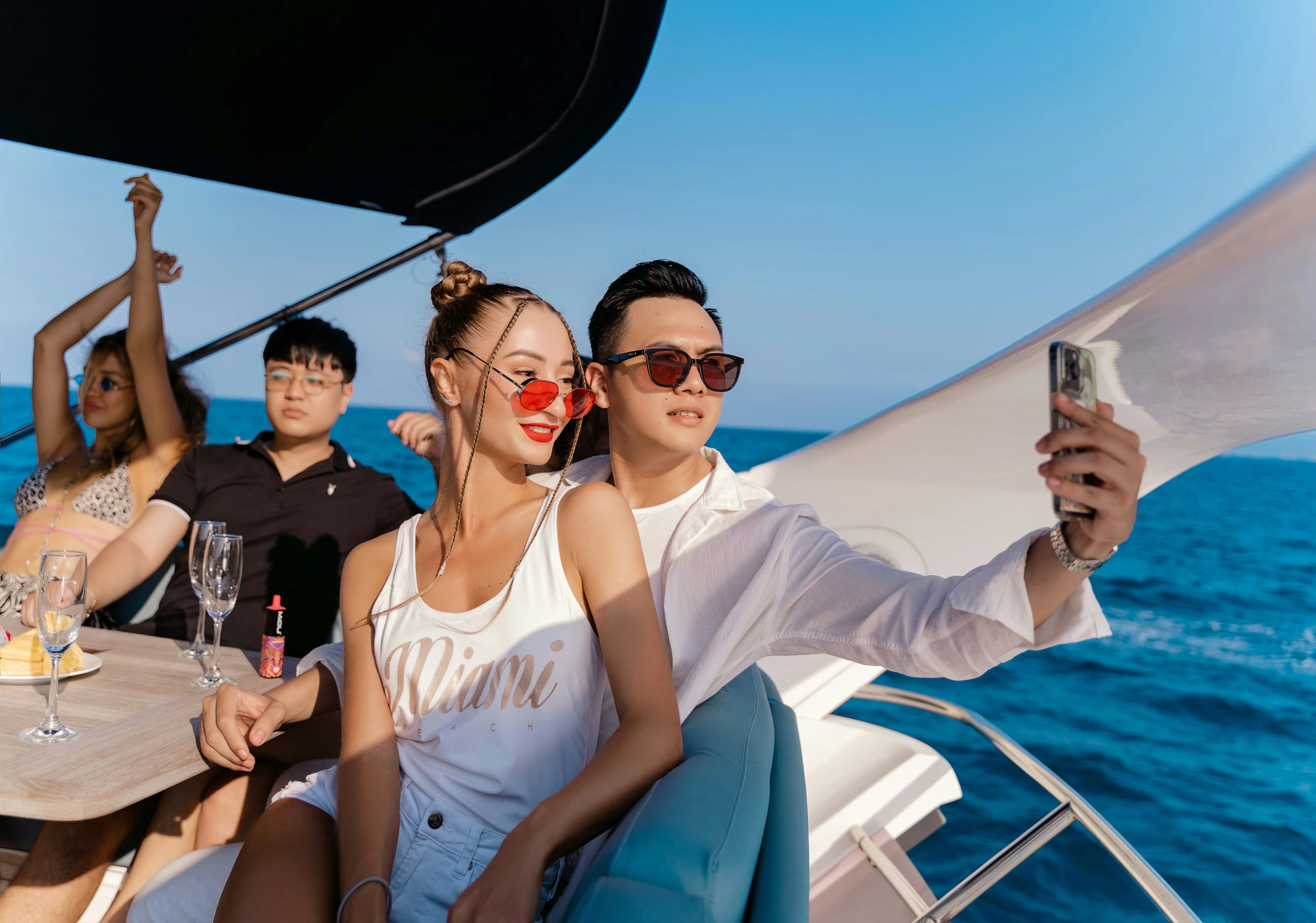 Couple sharing a romantic sunset moment on a yacht