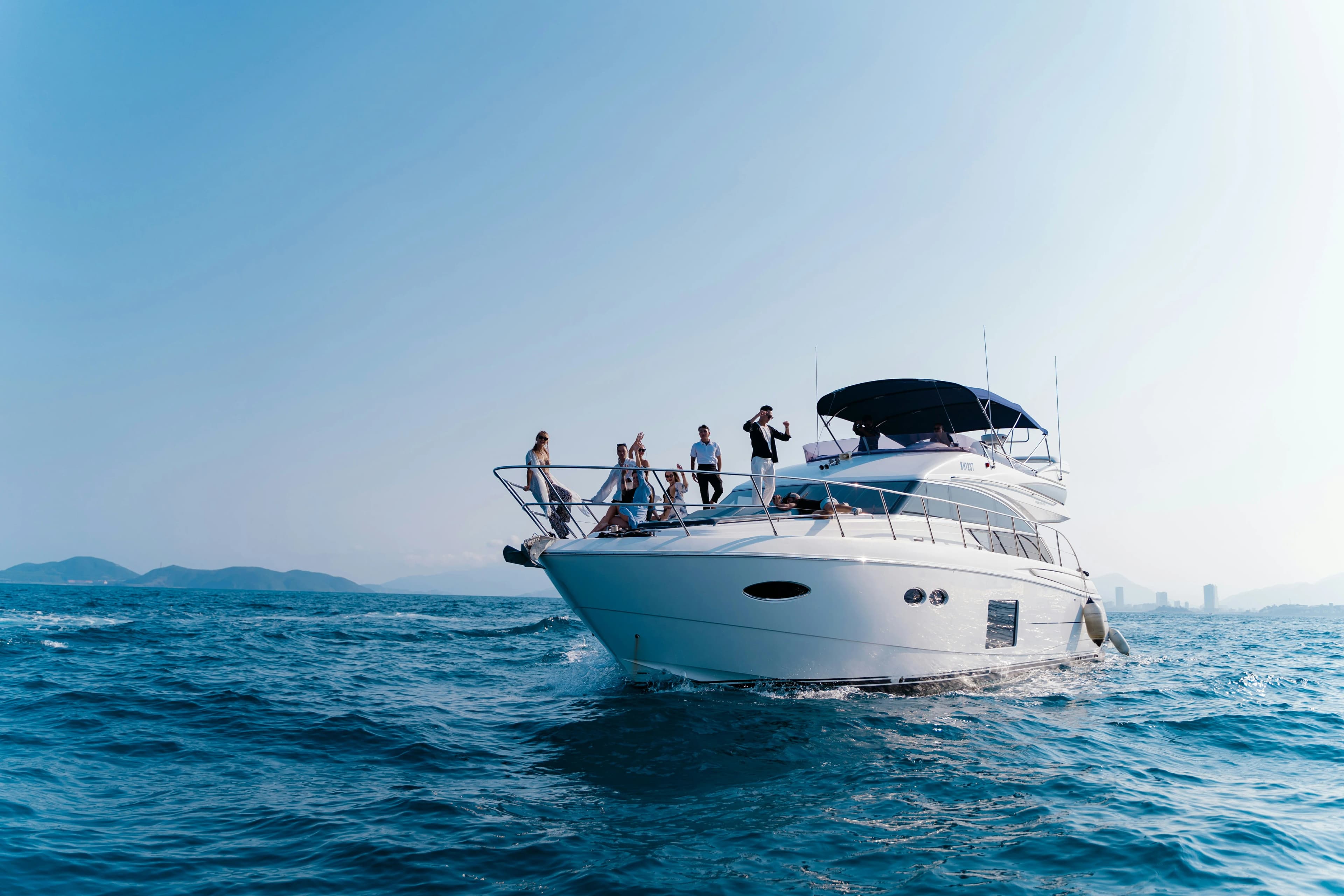 Luxury private yacht sailing at sunset in Dubai Harbour
